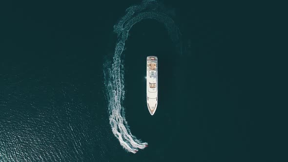 Top-down view of two jet-ski moving parallel to the large yacht. Super yacht