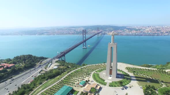 Aerial view of Sanctuary of Christ the King overlooking Lisbon and 25 de Abril Bridge connecting Lis