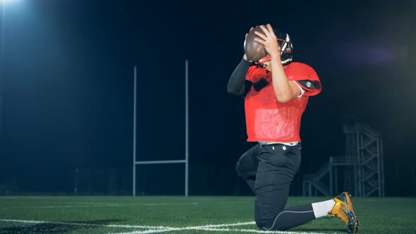 Sportsmen Training on a Field Kicking a Ball Back View