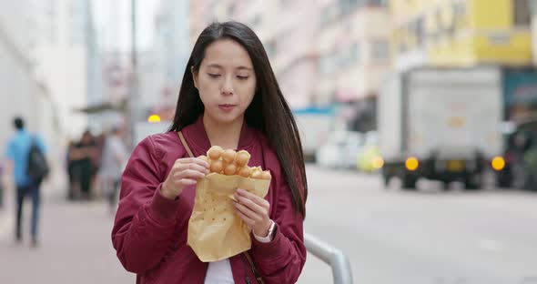 Woman eat local food, egg waffle in Hong Kong