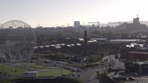 Aerial flyover of Belfast and the Rise Sculpture near the Falls Road and Westlink Motorway