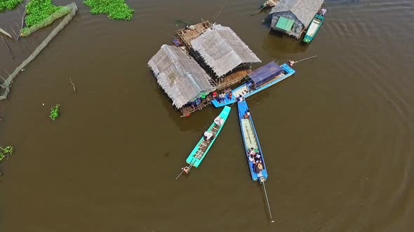 Locals Merchants Going About Everyday Life In The Floating Village Of Kompong Kleang In Cambodia -