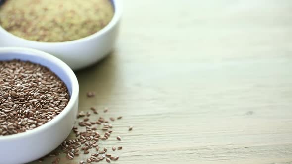 Flax seeds on painted wood board.