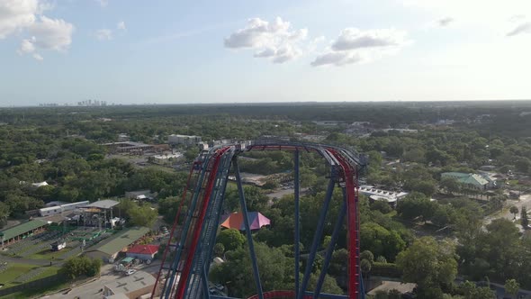 People riding an extreme roller coaster in theme park in Tampa, Florida Busch Gardens. Aerial view