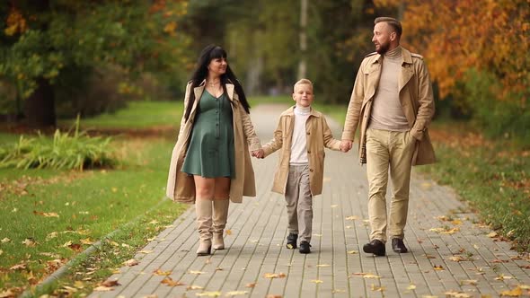 A Happy Family is Walking in the Park