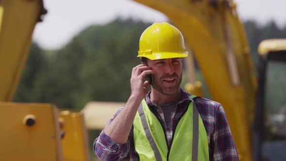 Construction worker talking on cell phone alt