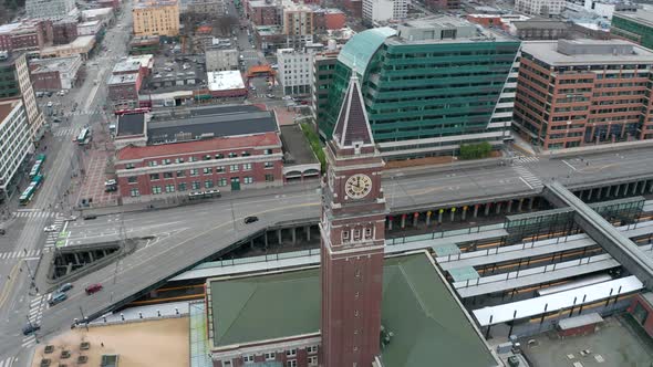 Orbiting aerial shot of the clock tower at King Street Station in Seattle, Washington.