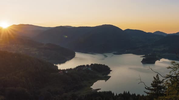 The sun's rays are moving above the mountains horizon at sunset