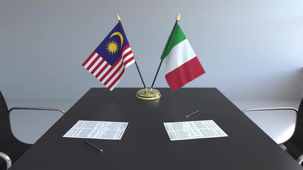 Flags of Malaysia and Italy and Papers