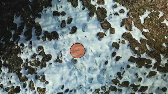 Drone landing on site. Landing mat on a wasteland. Aerial photography.