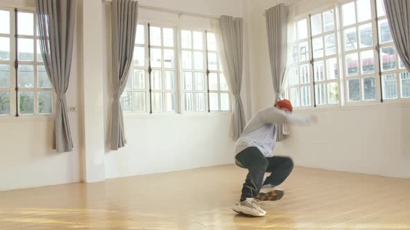 Young Man Hipster Is Performing Break dance Show In Studio