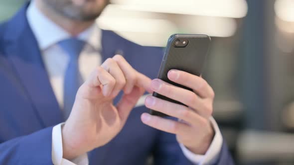 Close Up of Hands of Businessman Using Smartphone