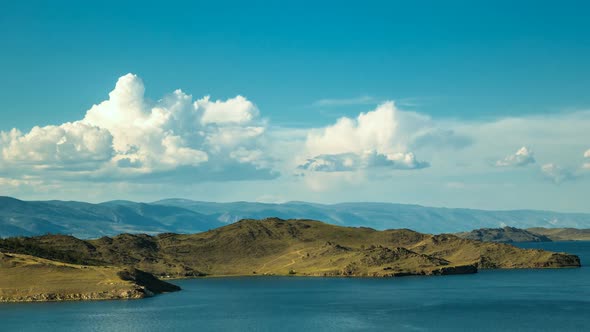  White Clouds Float Above the Smooth Lake