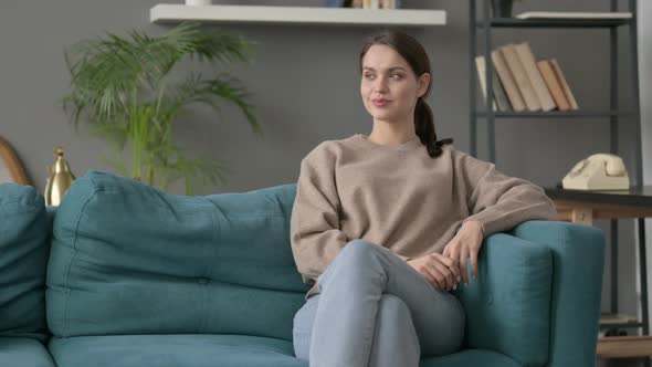 Woman Sitting on Sofa Thinking