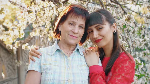 Adult Daughter Hugging Her Senior Mother