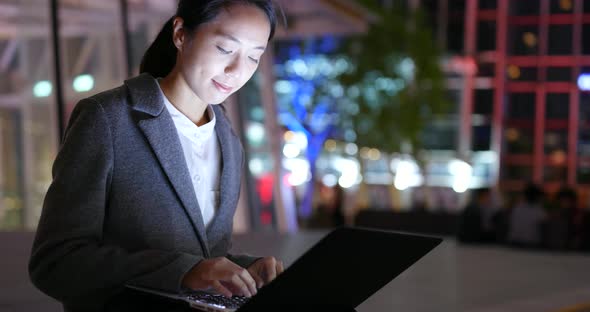 Woman work on laptop computer at night