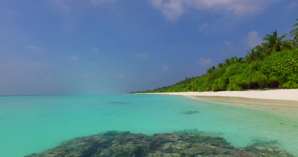 Natural aerial travel shot of a summer white paradise sand beach and blue water background in colorf