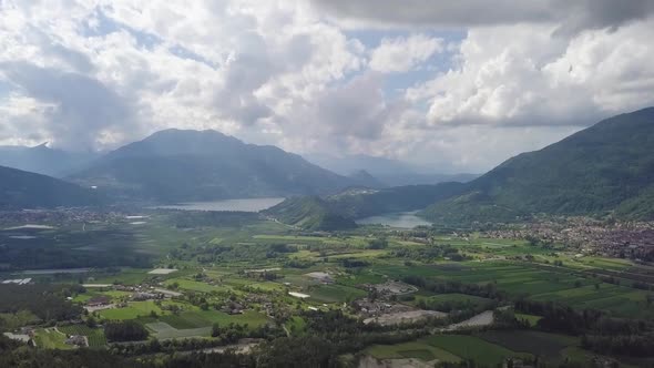 Aerial panoramic view of Borgo Valsugana in Trentino, Italy with drone flying forward and tilting do