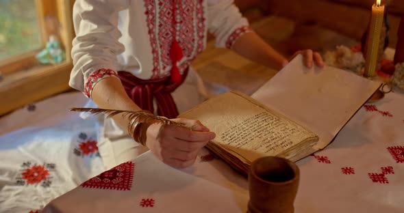 Closeup a Writing Pen in the Hand of a Slavic Man an Open Book with a Slavic Font