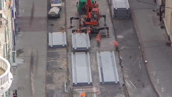 Installing Concrete Plates By Crane at Road Construction Site Timelapse