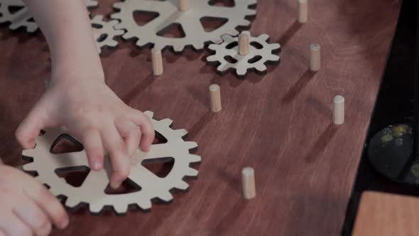 Closeup of a Child Who Collects Wooden Gears