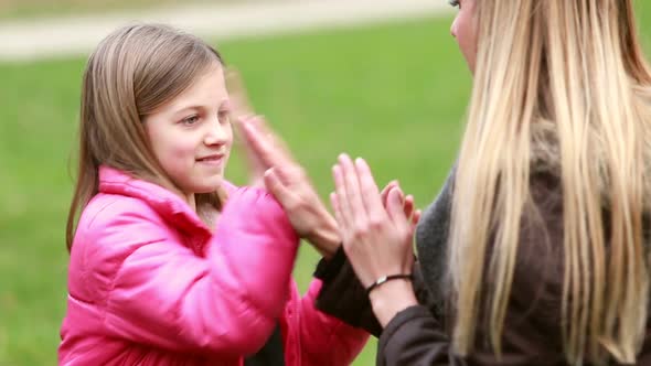 Mom and daughter playing clapping game