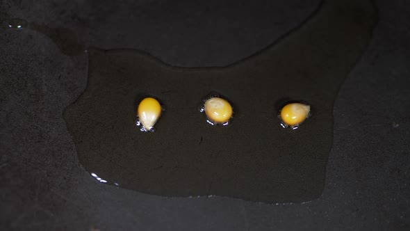 SLOW MOTION Kernels Of Popping Corn Pop In A Pan