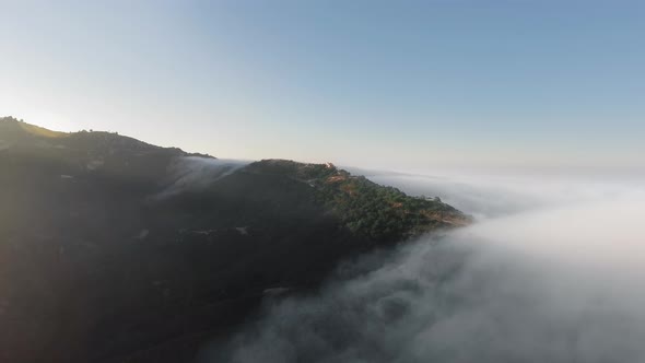 Drone shoots mountains under clouds in the morning in Malibu Canyon, Monte Nido, California, USA