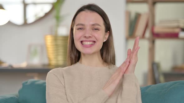 Portrait of Positive Young Woman Clapping at Home