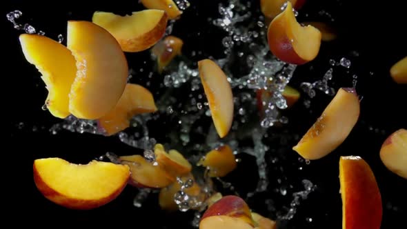 Slices of Peaches Bounce in Splashes of Water