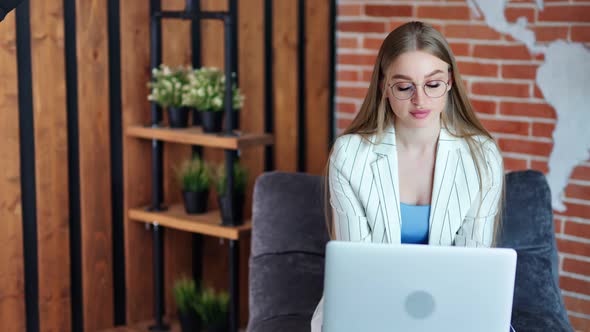 Adorable Young Casual Businesswoman Working on Laptop Pc at Modern Loft Office Medium Shot