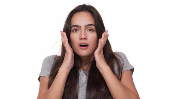 Portrait of Young Caucasian Woman Being Shocked Feeling Thrilled Covering Opened Mouth with Hands