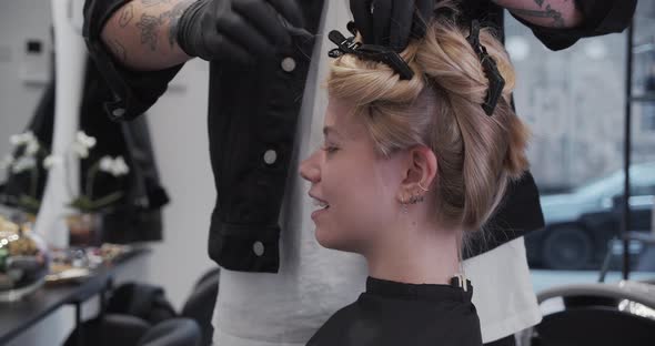 Hairdresser Putting Woman'S Hair In Bunches