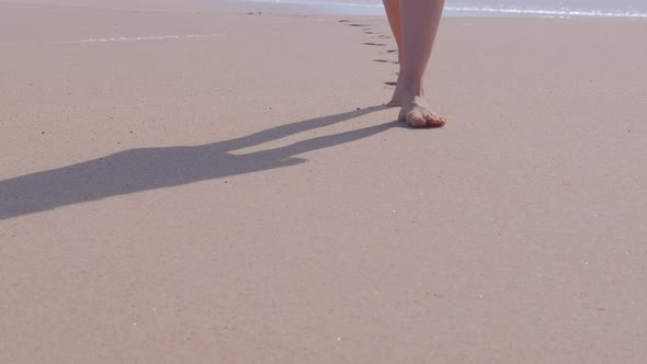 Woman Walking on Beach