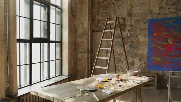 View of an Empty Art Studio with a Painting on an Easel