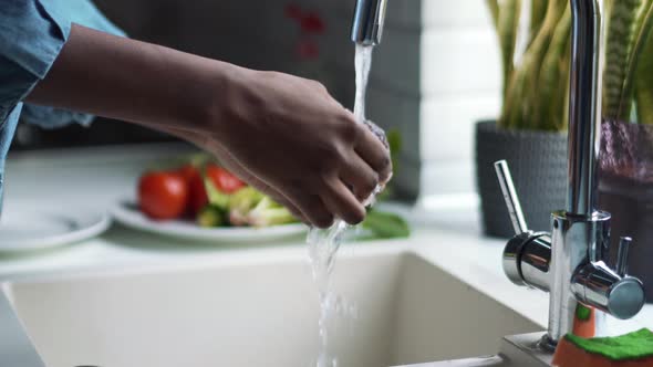 Female hands washing avocado