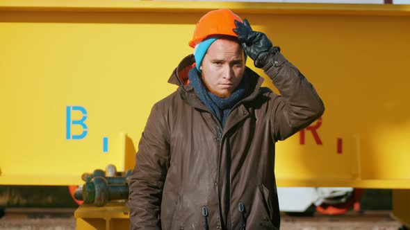 A Man Worker Put on an Orange Helmet and Posing