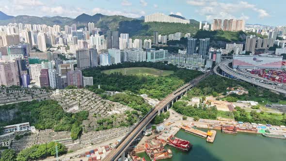 MTR pass over bridge near cemetery in Tsuen Wan, Hong Kong; panoramic aerial