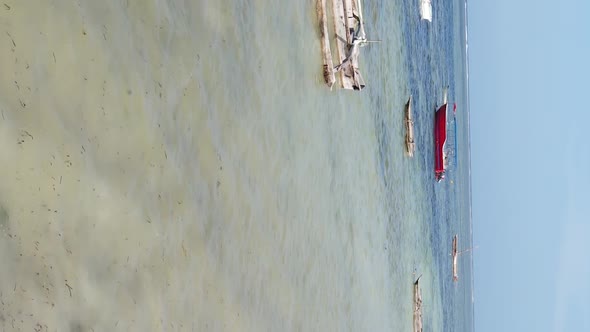 Vertical Video Boats in the Ocean Near the Coast of Zanzibar Tanzania Aerial View