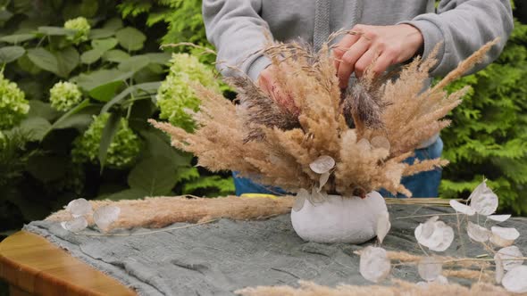 Woman Makes Autumnal DIY Flower Arrangement Using Dried Plants