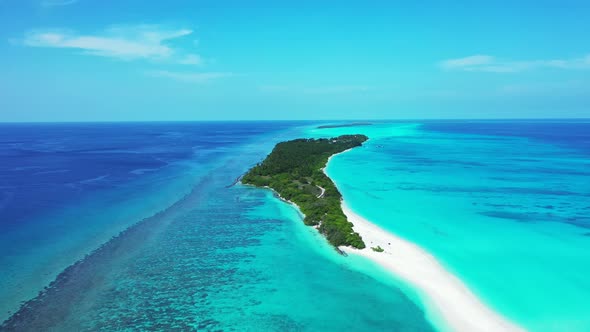 Natural birds eye clean view of a white paradise beach and aqua blue water background in high resolu