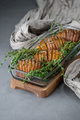 Baked potatoes with thyme in a glass container on a gray stone t - PhotoDune Item for Sale