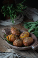 Whole baked potatoes with thyme in a wooden plate on an old rust - PhotoDune Item for Sale