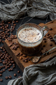 Coffee with milk foam on a wooden board and a scattering of coff - PhotoDune Item for Sale