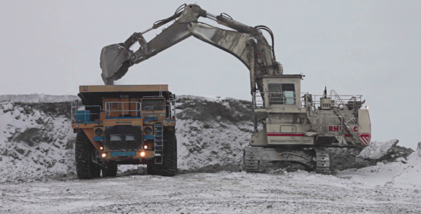 Dump Truck Loaded With An Excavator