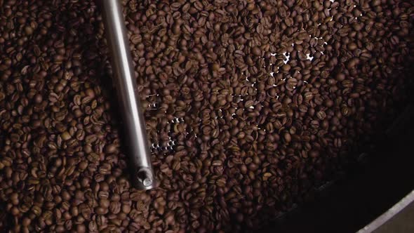 Over head shot of coffee beans being turned in roaster