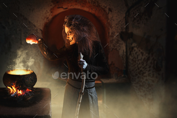 dy parts, dark powers of witchcraft, spiritual seance with candles. Female foreteller calls the spirits, terrible future teller