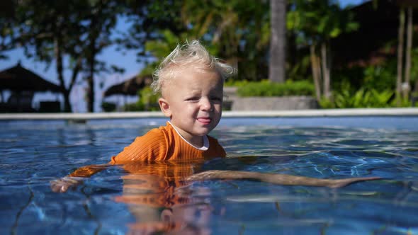 Portrait of Cute Little White Baby Swimming in a Pool