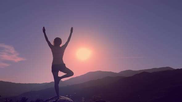 Woman Practicing Yoga on Mountain Peak