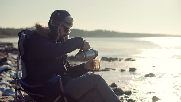 Man Warming Hands Steaming Cup Of Mate Tea. Male Hands With Mug Of Hot Drink Cold Winter Outdoors.